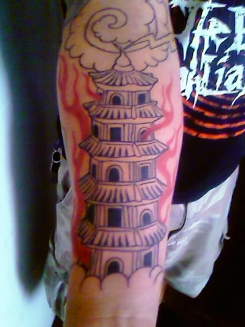 Nice tattoo of an Asian Pagoda Burning in Flames
